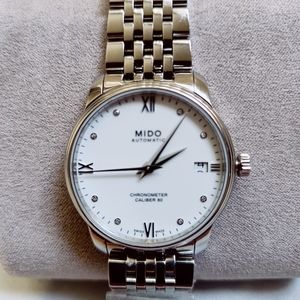 The Mido Baroncelli women's stainless steel watch measures at 34mm wide with a s